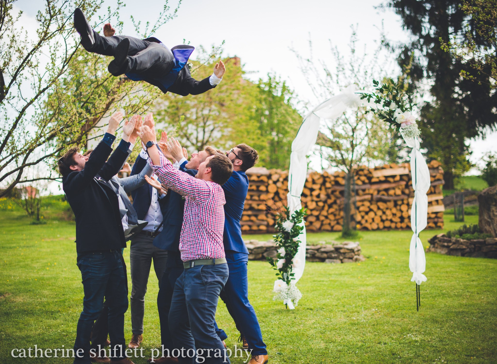 Catherine Shiflett Photography, wedding photography, groom being thrown into the air by his best men, shot on Nikon D800